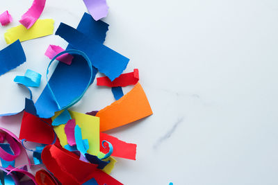 Close-up of multi colored toys over white background