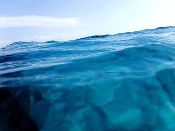 Close-up of rippled water against blue sky