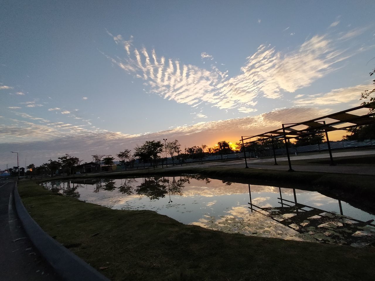 SCENIC VIEW OF SWIMMING POOL AGAINST SKY DURING SUNSET