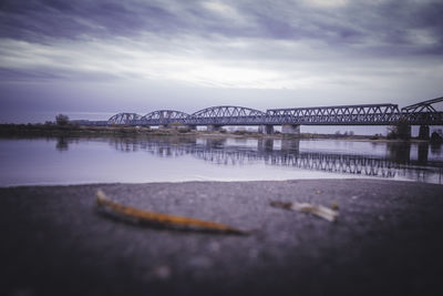 Bridge over river against sky in city