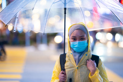 Portrait of woman holding umbrella