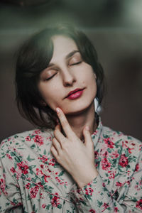 Portrait of beautiful young woman with eyes closed