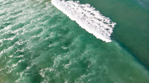 High angle view of surf on beach