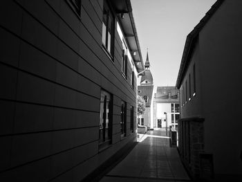 Empty alley amidst buildings in city