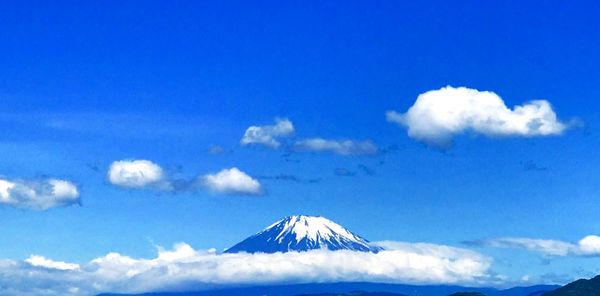 Scenic view of snowcapped mountains against blue sky