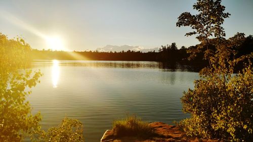 Scenic view of lake against sky during sunset