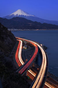 High angle view of light trails on road against sky