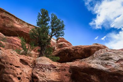 Low angle view of rocks on mountain against sky