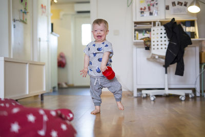 Happy boy at home barefoot