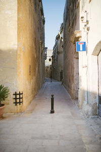 Footpath amidst buildings in town