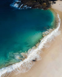 High angle view of surf on beach