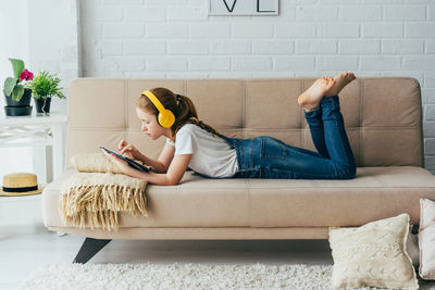 Girl using digital tablet at home