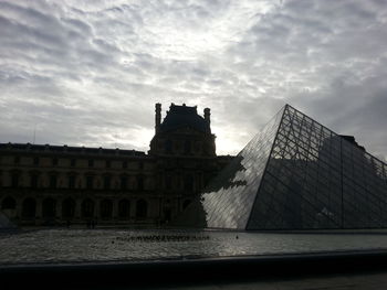 Low angle view of building against cloudy sky