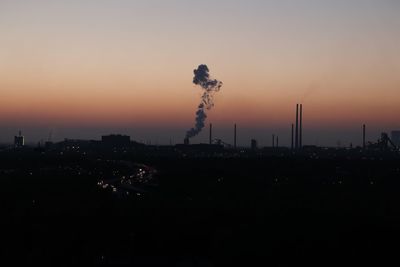 Silhouette of cityscape against sky during sunset