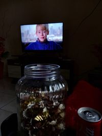 Portrait of boy in jar at home