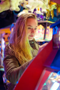 Side view of young woman in store