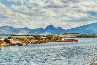 Scenic view of lake and mountains against sky