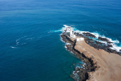 Aerial view of rock formations in sea