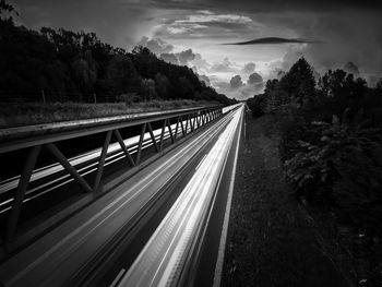 Road leading towards mountain against sky