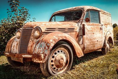 Abandoned car on field