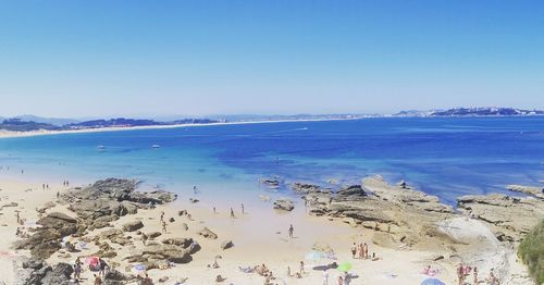 Scenic view of beach against blue sky