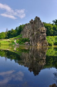 Scenic view of lake by trees against sky externsteine 