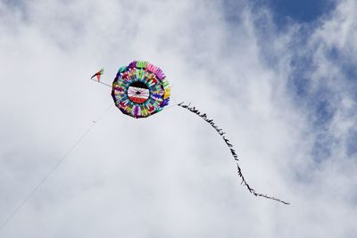 Low angle view of kite flying against sky