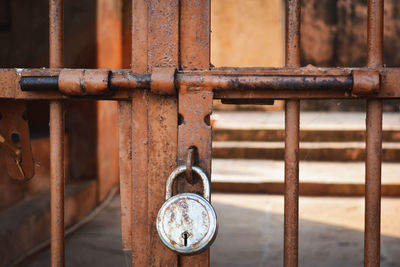 Old rusted metal door with latch and padlock