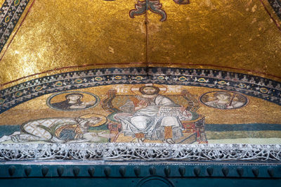 Low angle view of carvings on wall in building