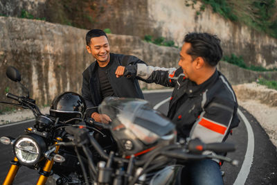 Portrait of man riding motorcycle on road