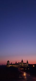 Silhouette building against clear sky at night