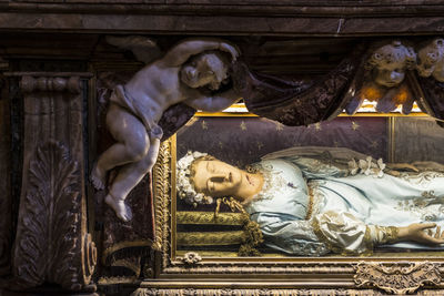 Low angle view of angel statue against building