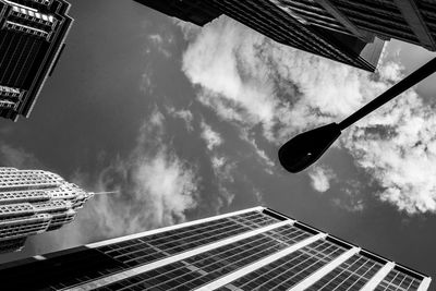 Low angle view of street light and buildings against sky