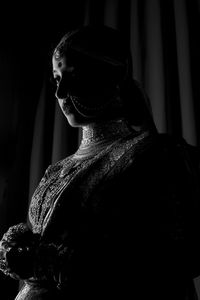 Low angle view of bride standing in darkroom