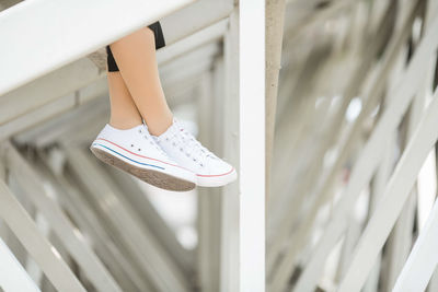 Low section of woman wearing canvas shoes