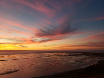 Scenic view of sea against romantic sky at sunset