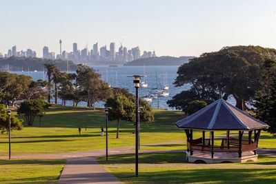 Park by buildings against sky in city