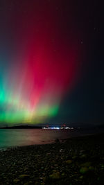 Scenic view of sea against sky at night