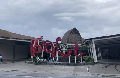 View of red building against cloudy sky