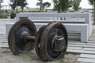 Rusty wheels in garden by seats