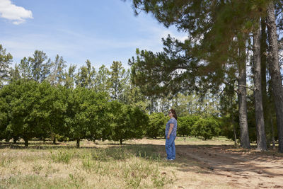 Rear view of woman standing on field