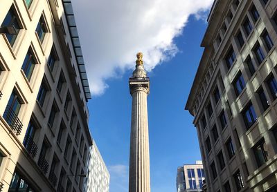 Low angle view of clock tower against cloudy sky