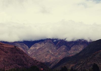 View of mountain range against cloudy sky