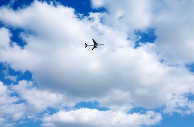 Low angle view of airplane flying in sky