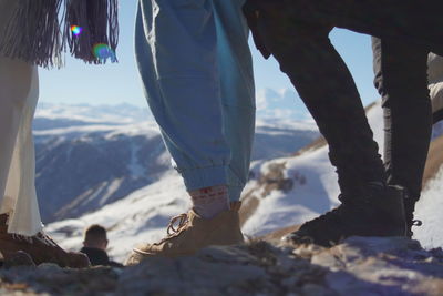Low section of women standing on mountain