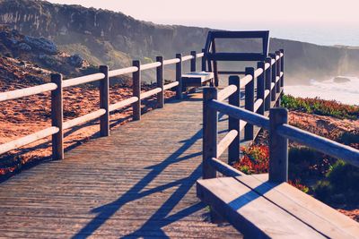 View of walkway leading towards water