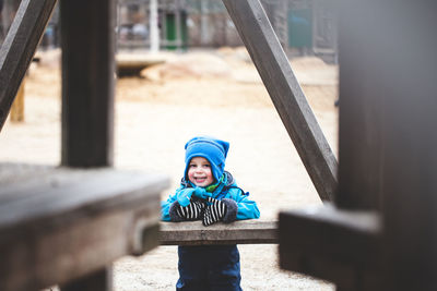 Portrait of boy sitting in playground