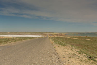 Empty road along countryside landscape