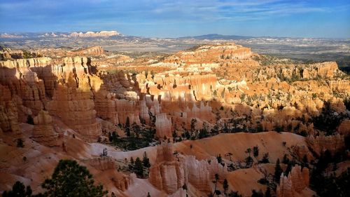 Panoramic view of rock formations against cloudy sky