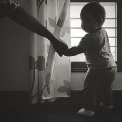 Side view of boy standing at home